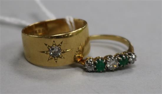 An early 20th century 18ct gold and gypsy set diamond ring and an 18ct gold, emerald and diamond five stone ring.